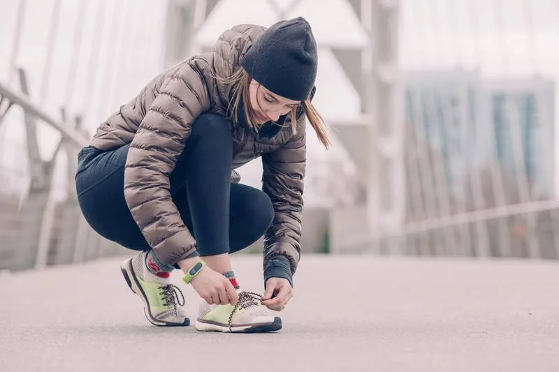 Woman athlete tying shoes